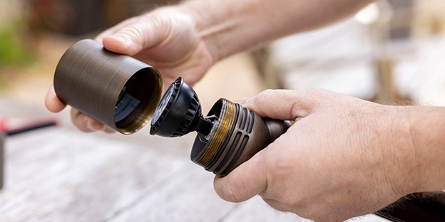 Person assembling a landscape lighting fixture.