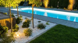 RGB landscape uplights accenting a backyard pool area.