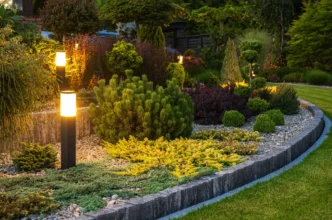 Tiered backyard garden with LED bollard lights providing a beautiful layered lighting design.