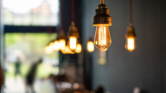 Retro industrial style string light bulb inside building.