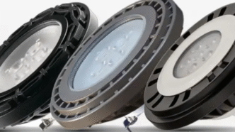 Three different par36 outdoor lighting bulbs against a neutral, monochromatic backdrop.