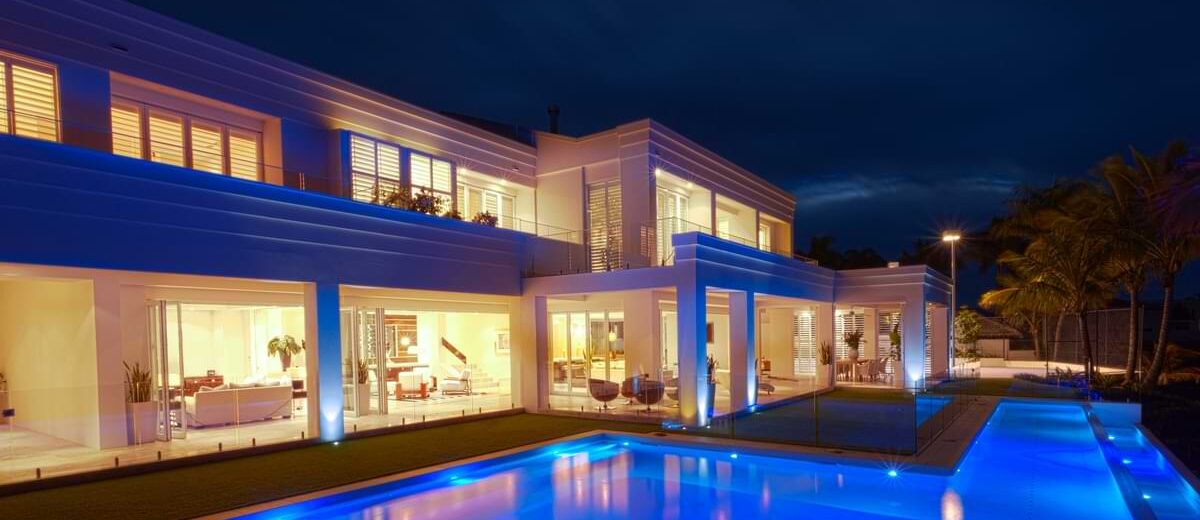 Backyard swimming pool of an extravagant, modern home.