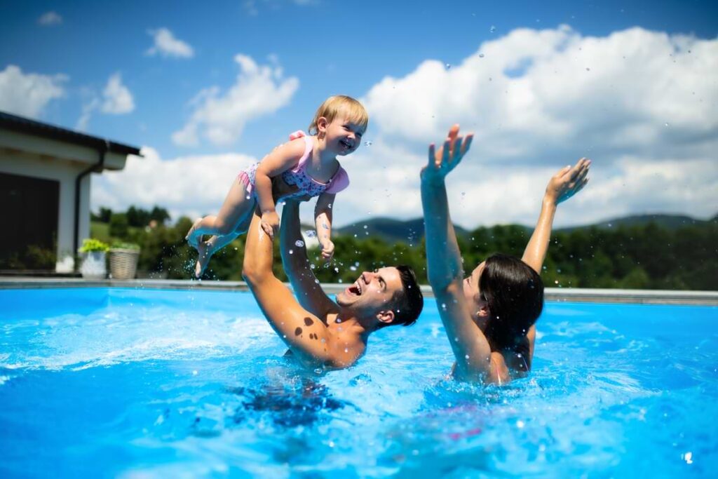 Happy family in a swimming pool.