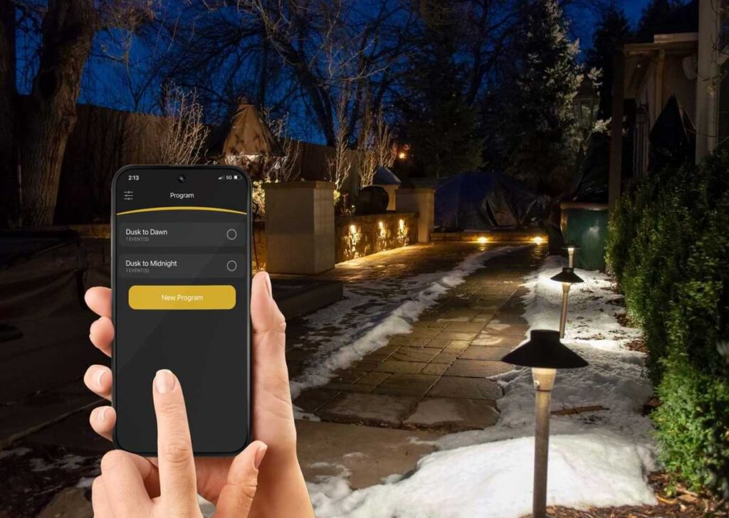 Person controlling landscape lighting with Alliance itPRO app.