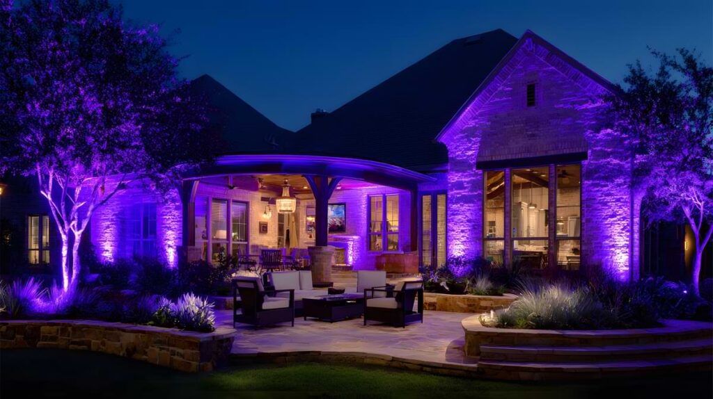 Backyard of upper middle class home bedecked with purple rgb lights.